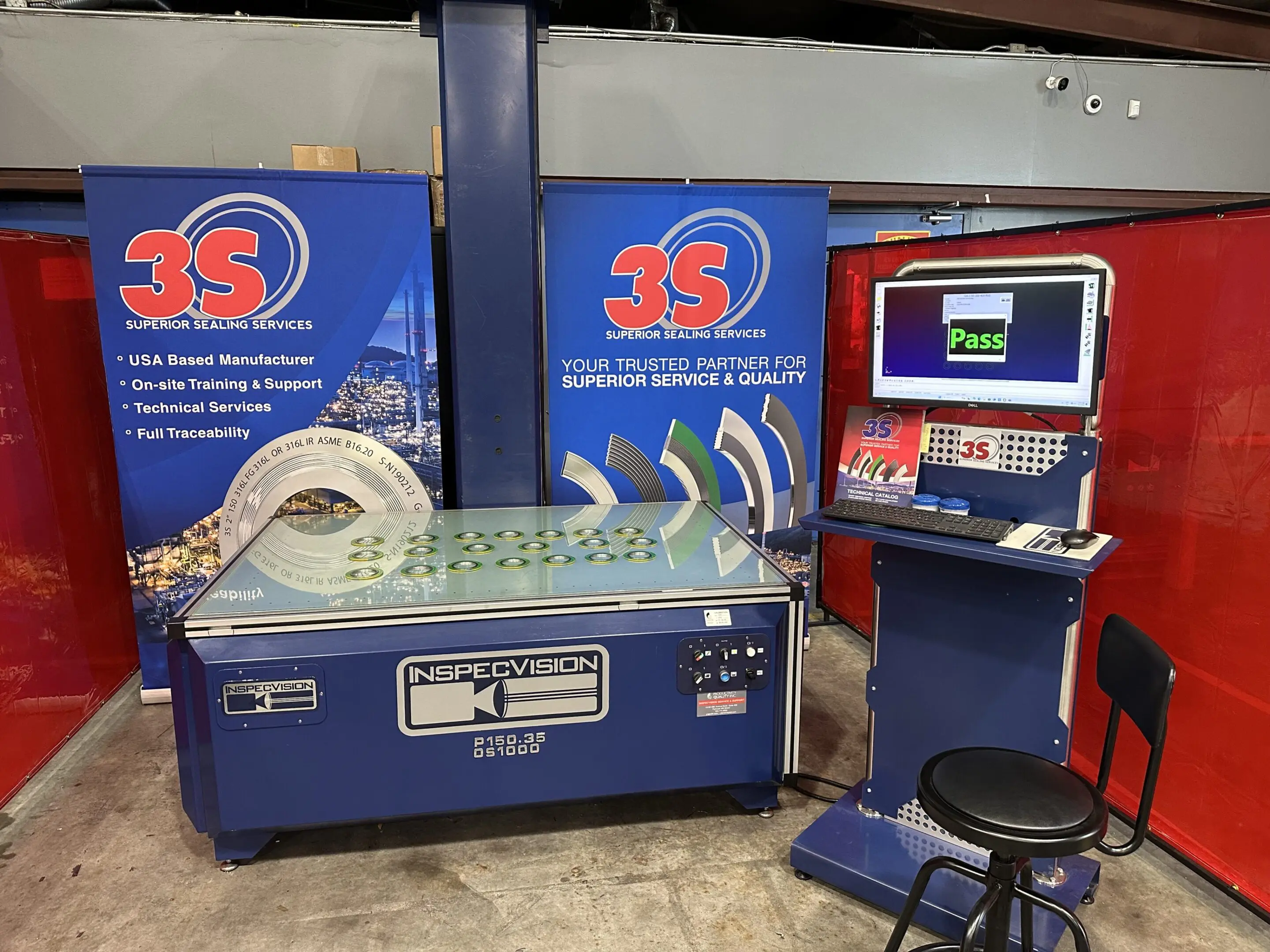 6813cfe5e0e55_Inspection Machine 1 A blue machine with two monitors and a stool